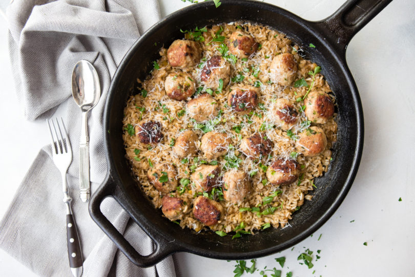 brown rice and turkey meatballs in a cast iron skillet