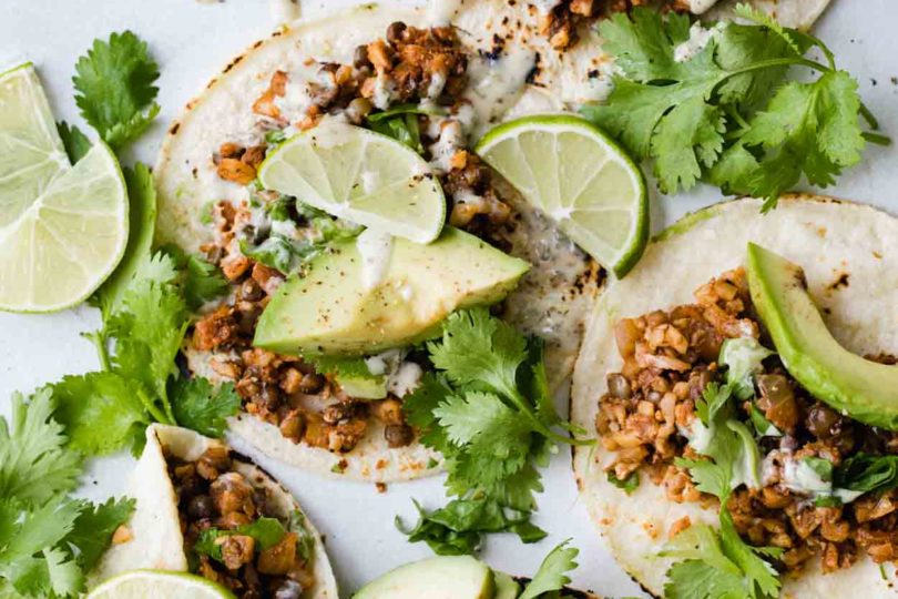 Cauliflower rice tacos on flour tortillas with cilantro, avocado and limes