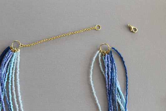gold chain attached to the seed bead necklace with a small jump ring on the end