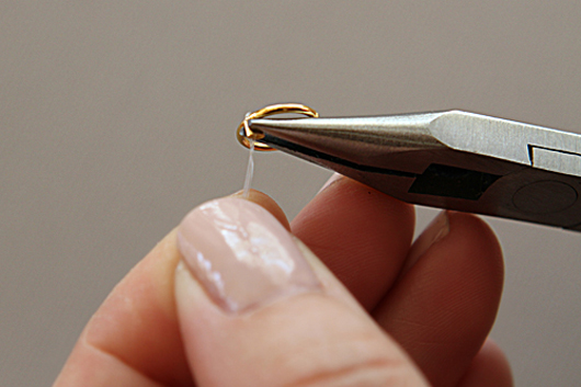 closing the crimp bead with a pair of needle nose pliers