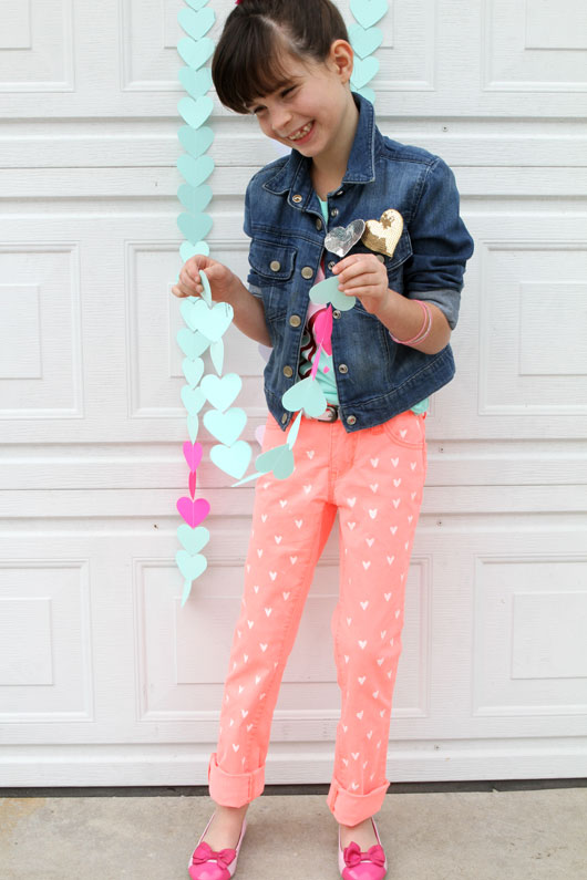 little girl giggling holding paper garland