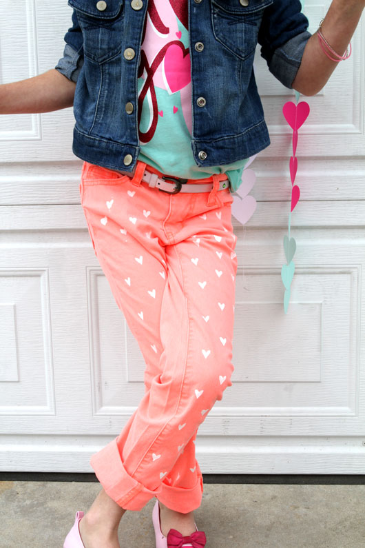 little girl wearing pink shoes and denim jacket and coral jeans