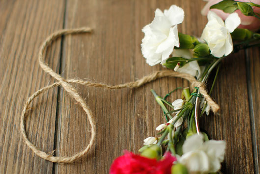 jute string tied to a metal hoop decorated with flowers