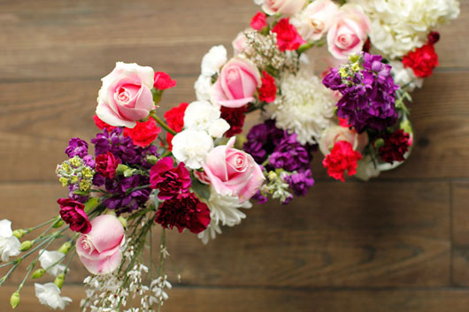 roses and carnations tied to a metal hoop