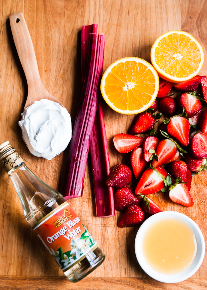 rhubarb, oranges, rose water and yogurt on a cutting board