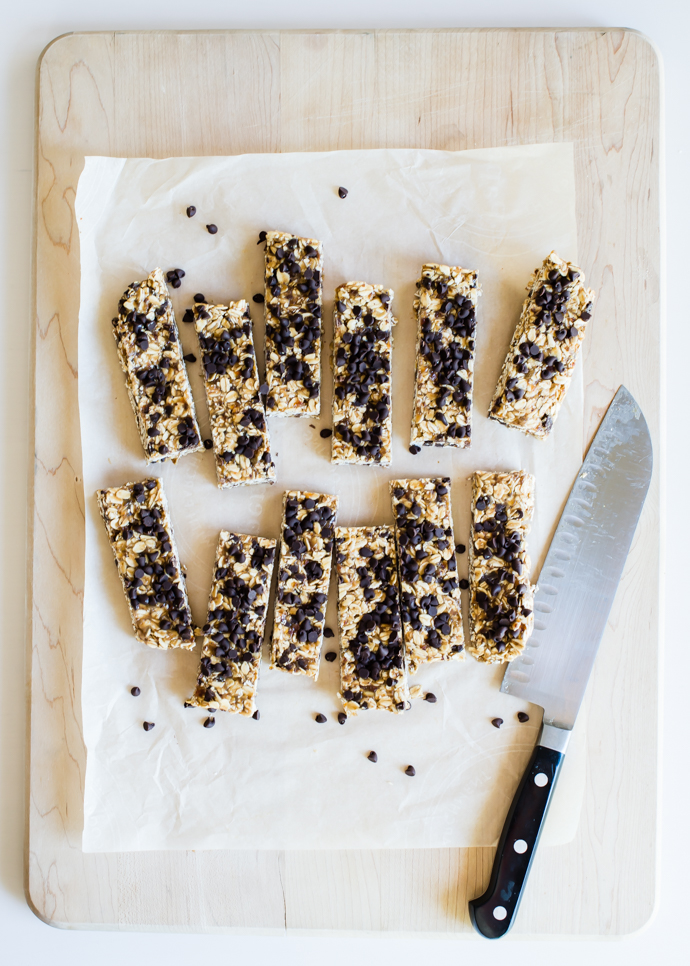 chewy chocolate chip granola bars cut into strips on a cutting board
