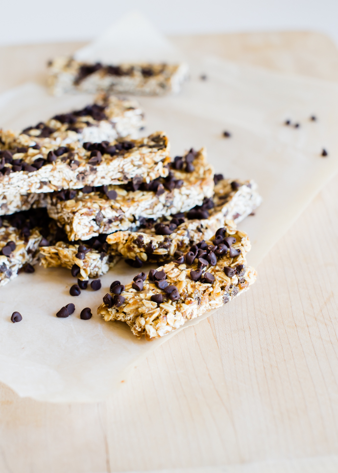 tahini granola bars sliced and stacked on a wax paper