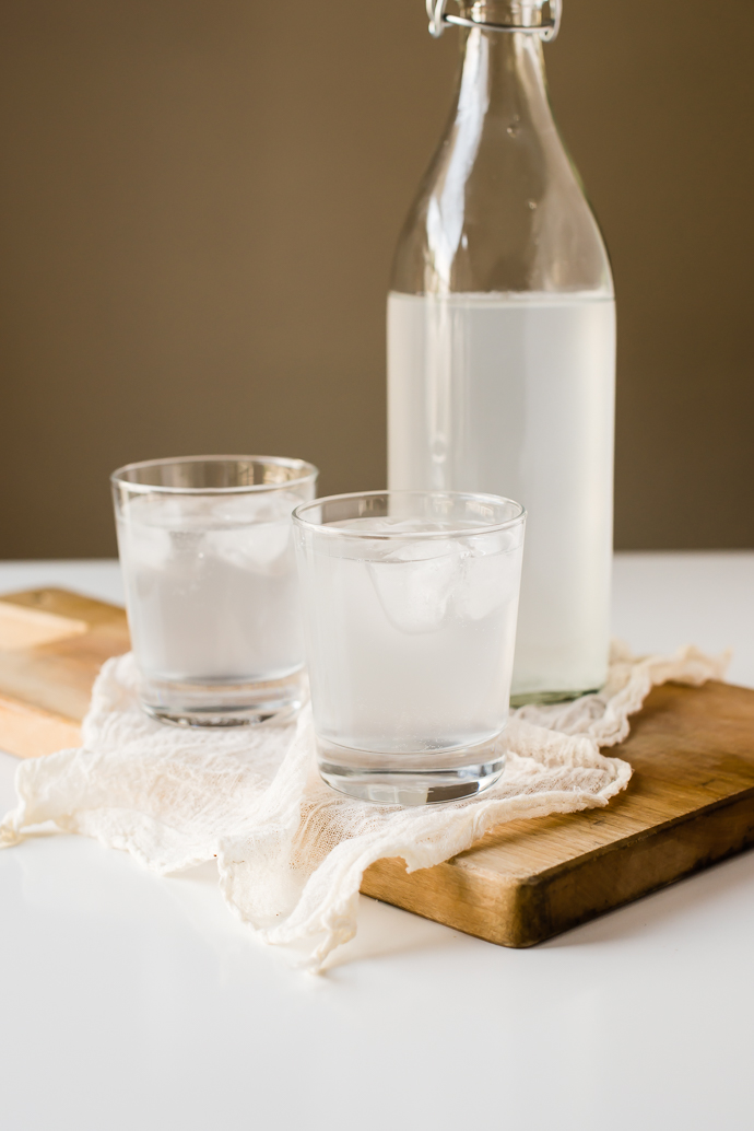 organic water kefir in two glasses and a glass bottle