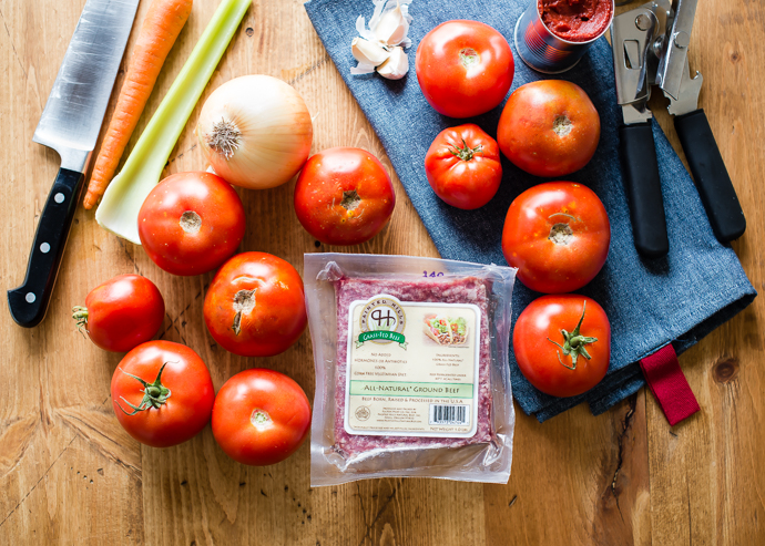 slow cooker tomato sauce ingredients- tomatoes, ground beef, garlic, tomato paste, onions, celery, carrots