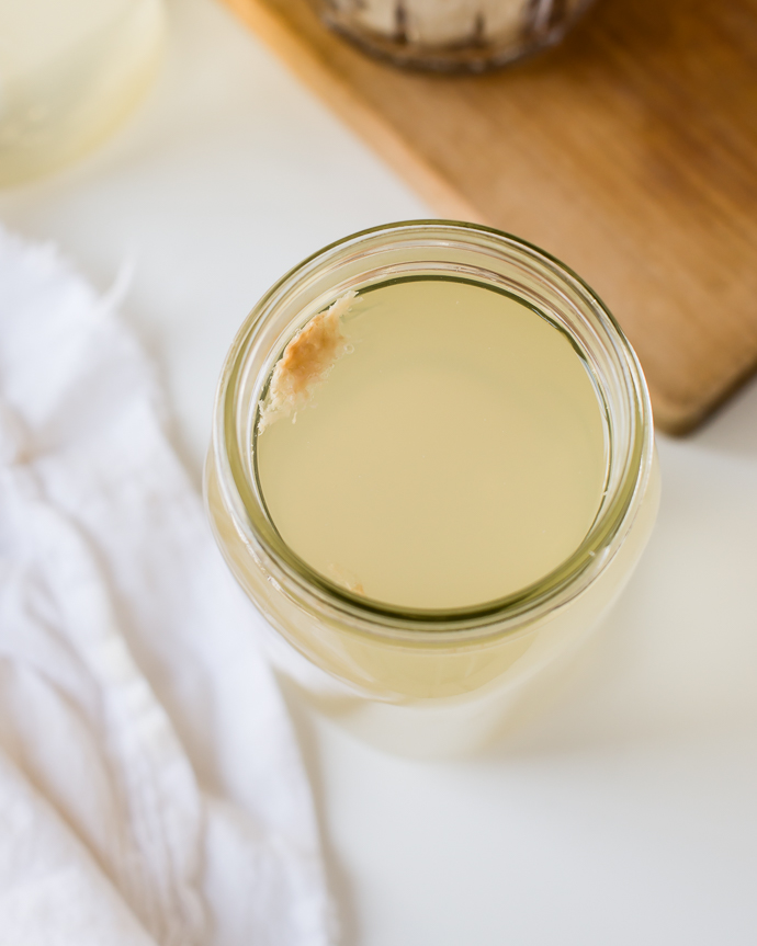 yeast growing on the side of the mason jar in kefir