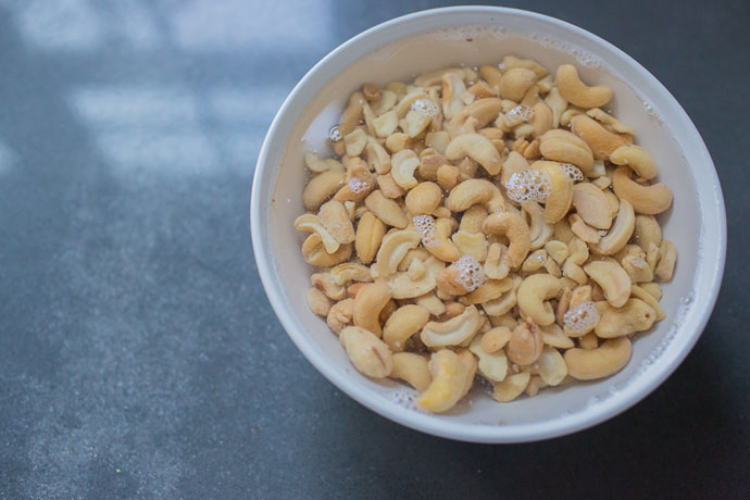 white bowl filled with water and cashews