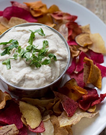 bowl of cashew cream dip surrounded by veggie chips
