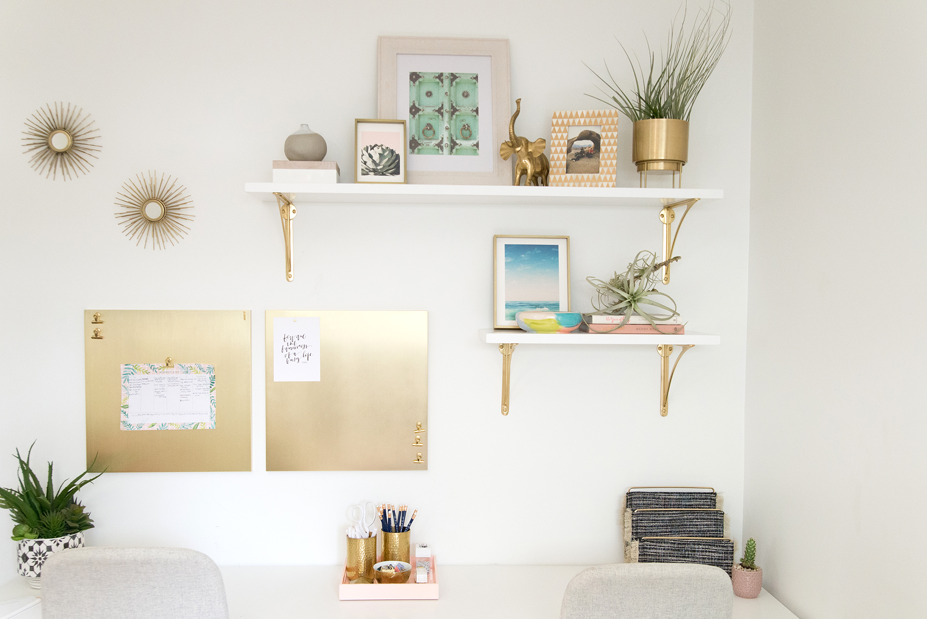 office wall with white and gold shelves and decor