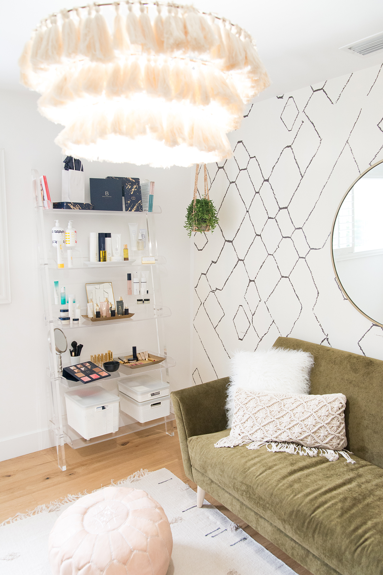 clear acrylic wall shelf that holds Beauty Counter makeup