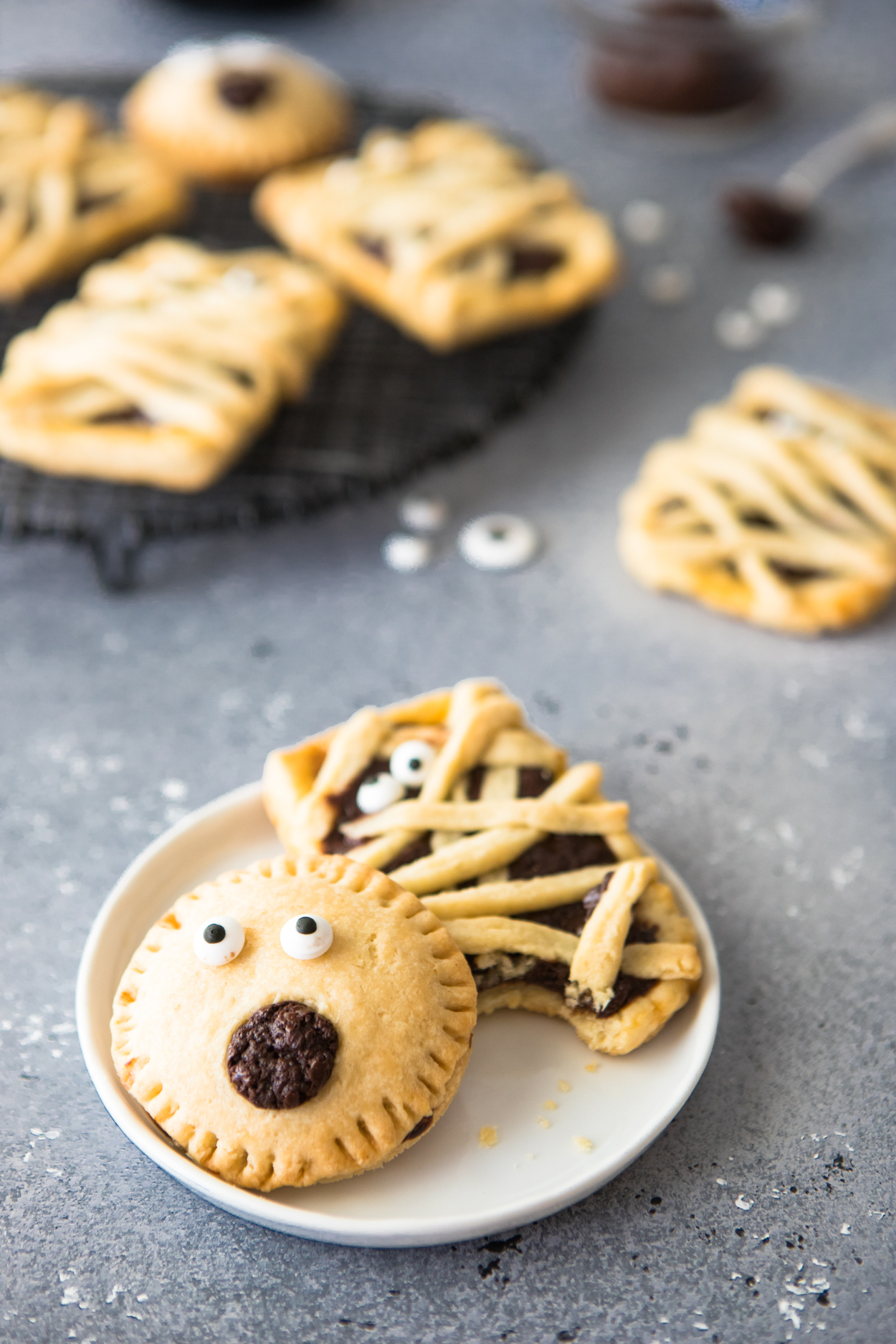 Chocolate filled hand pies on a black baking rack against a gray backdrop 