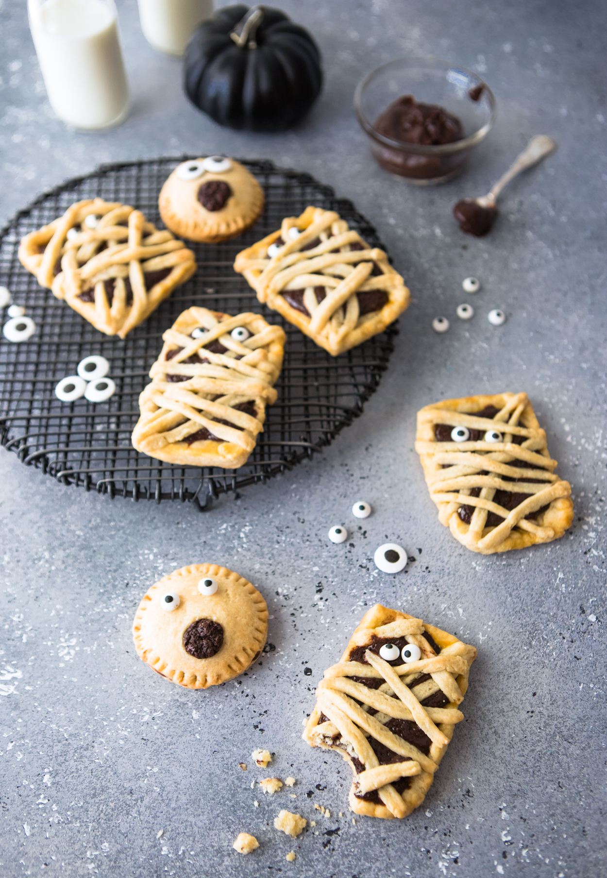 Chocolate filled hand pies on a black baking rack against a gray backdrop 