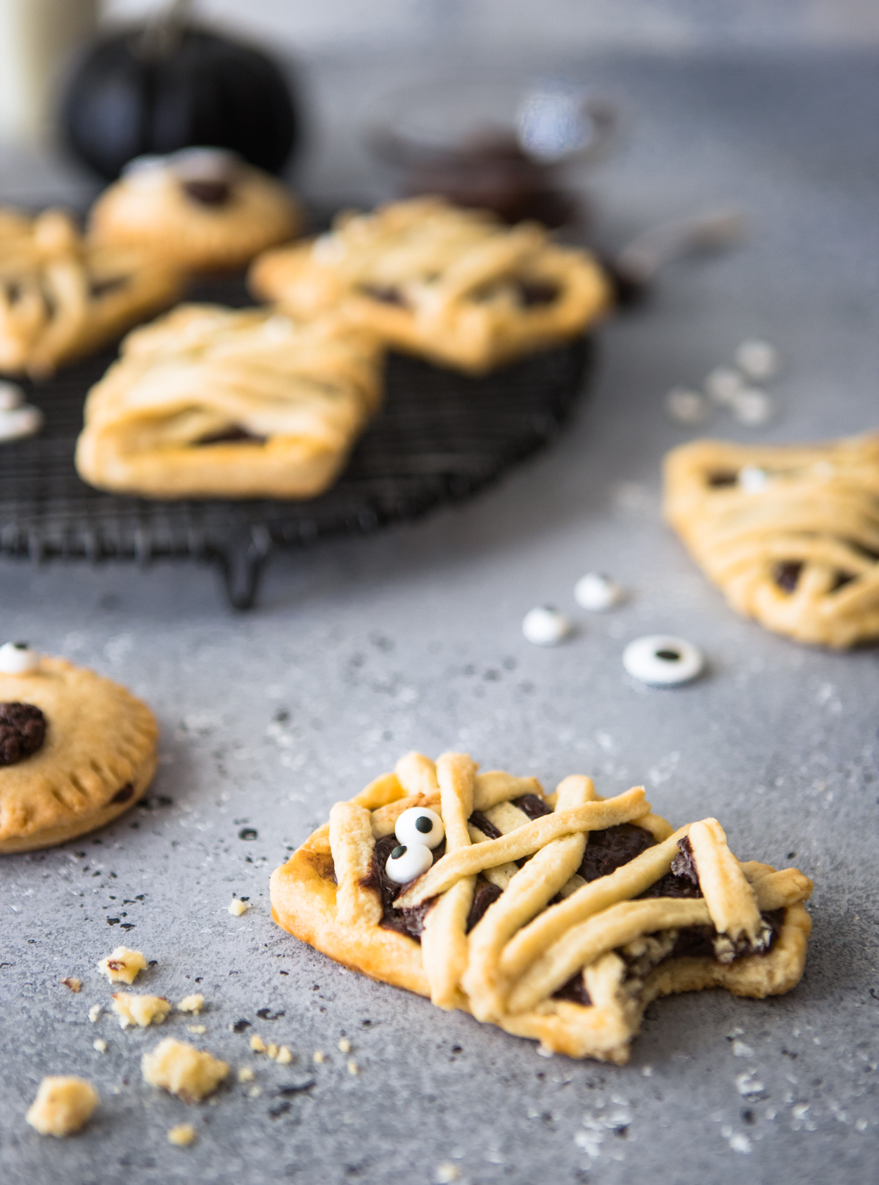 Mummy decorated chocolate hand pies against a gray backdrop