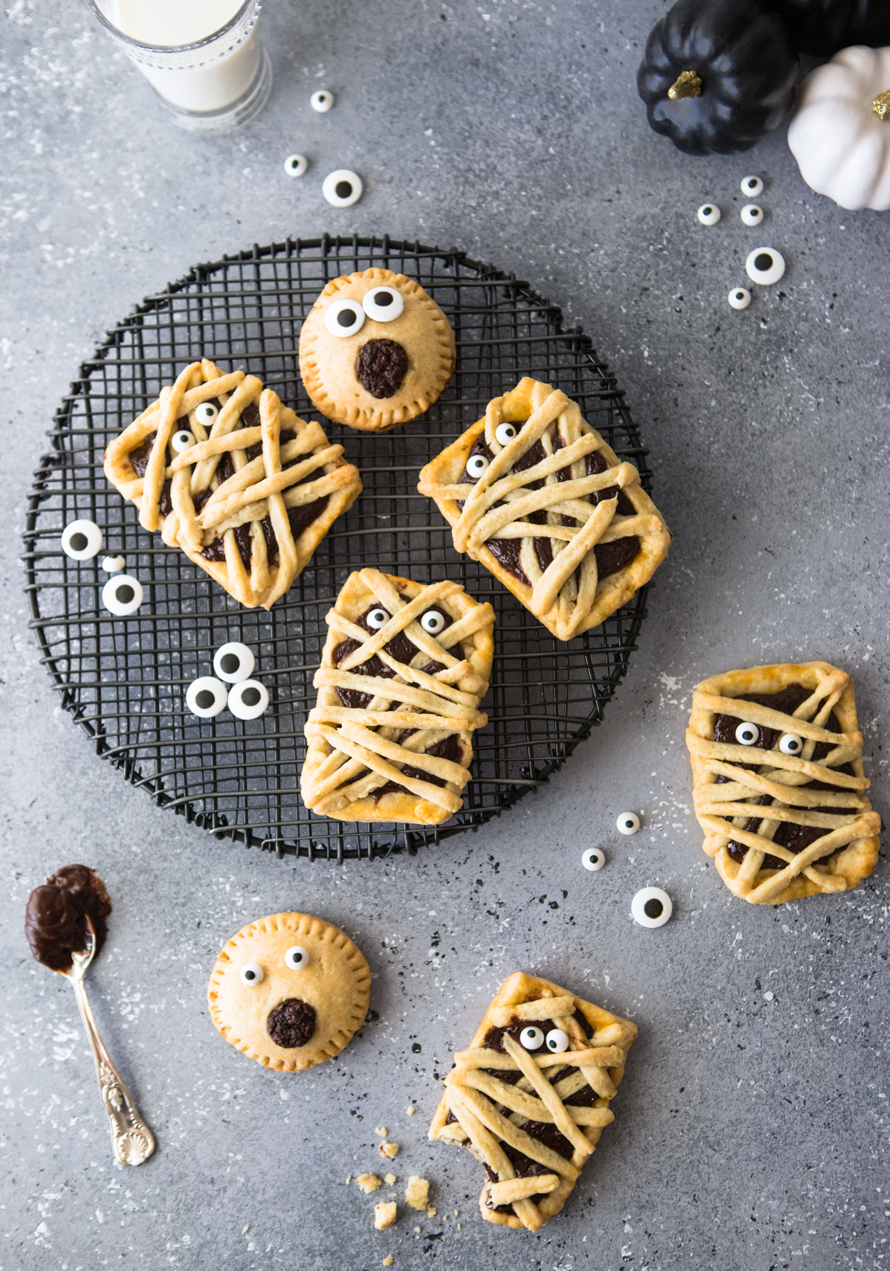 Chocolate filled hand pies on a black baking rack against a gray backdrop 