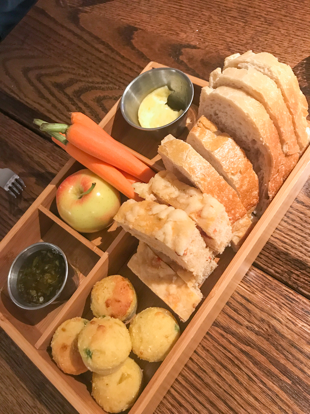 New England bread box with bread, apples and butter on a table at Marsh Tavern at Equinox Resort in Manchester Vermont