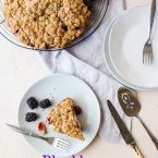 Slice of Blackberry Cake on a gray plate with a fork on a white background