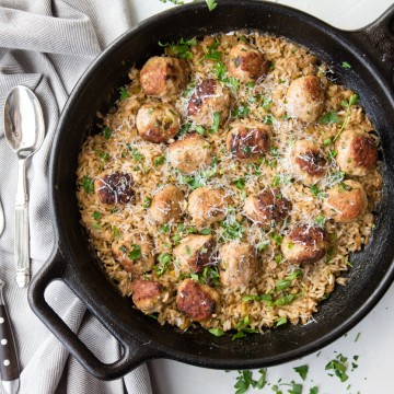 brown rice and turkey meatballs in a cast iron skillet