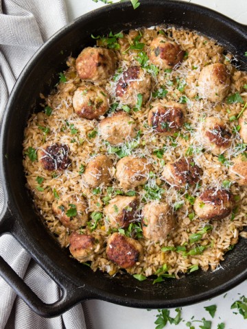 brown rice and turkey meatballs in a cast iron skillet