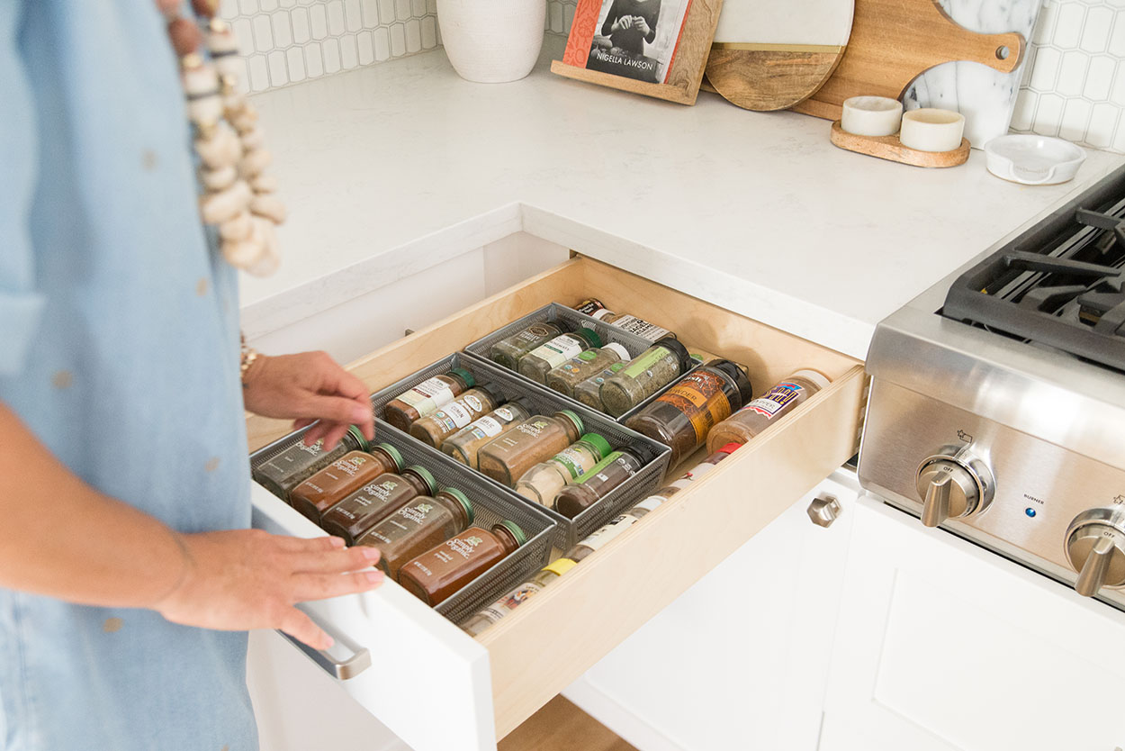 woman next to drawer of spices and herbs