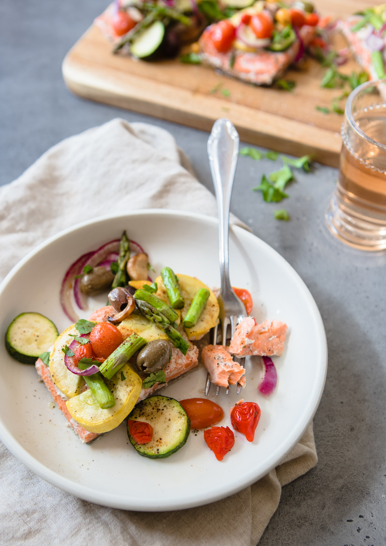 a bite of salmon being taken with a fork