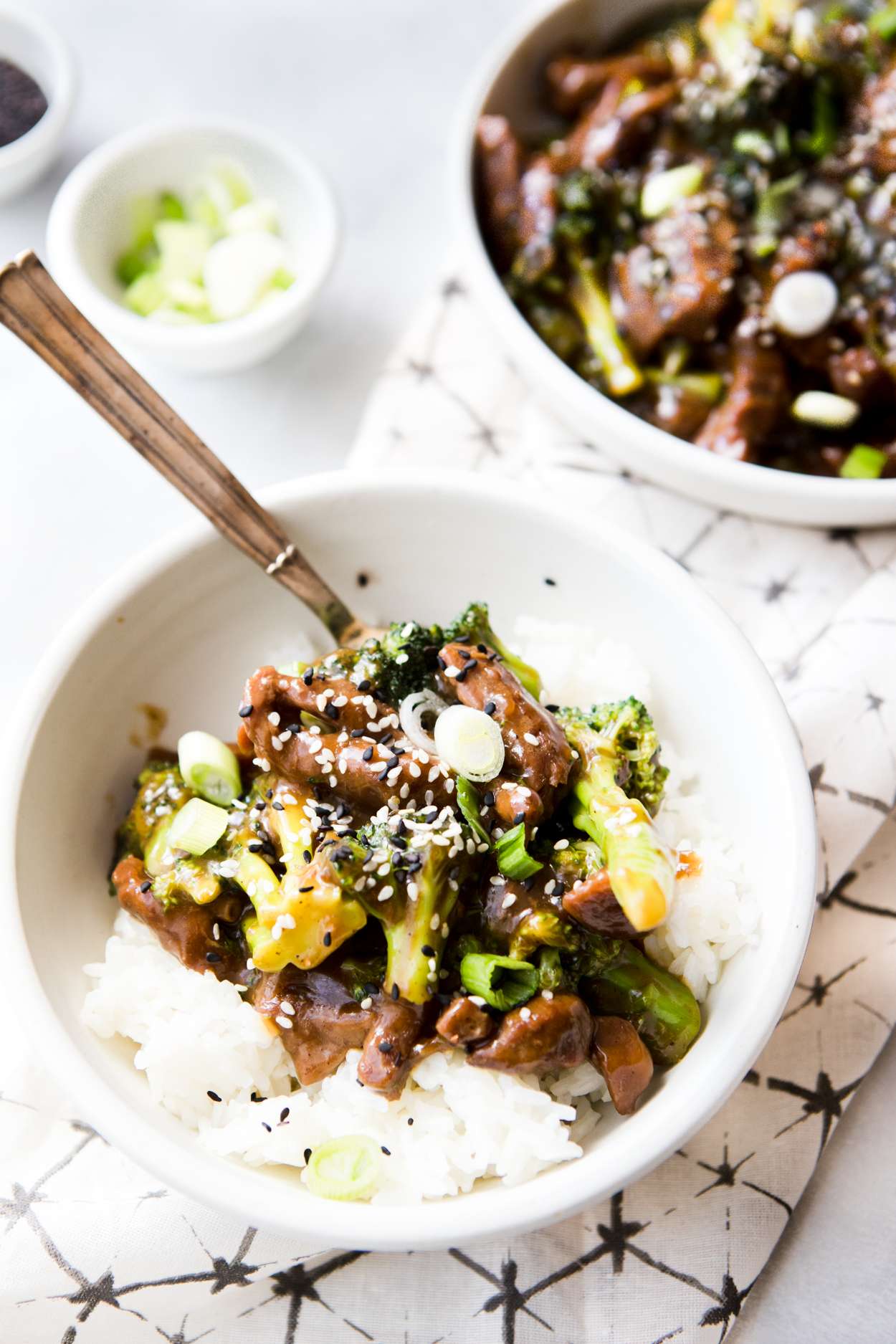 Instant Pot Beef and Broccoli over rice in a white bowl 
