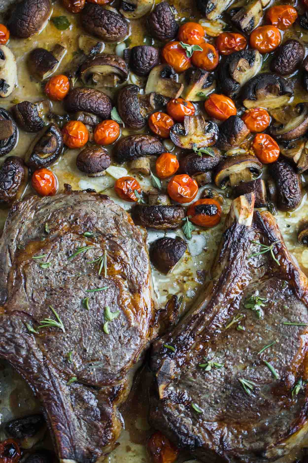 Steak, mushrooms and tomatoes on a sheet pan with fresh herbs and Marsala wine