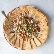 hummus with parsley, tomatoes, feta and eggplant