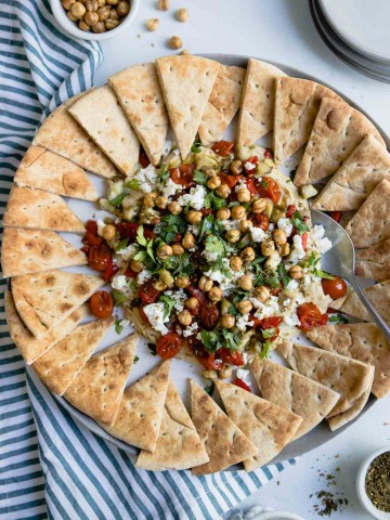 hummus with parsley, tomatoes, feta and eggplant