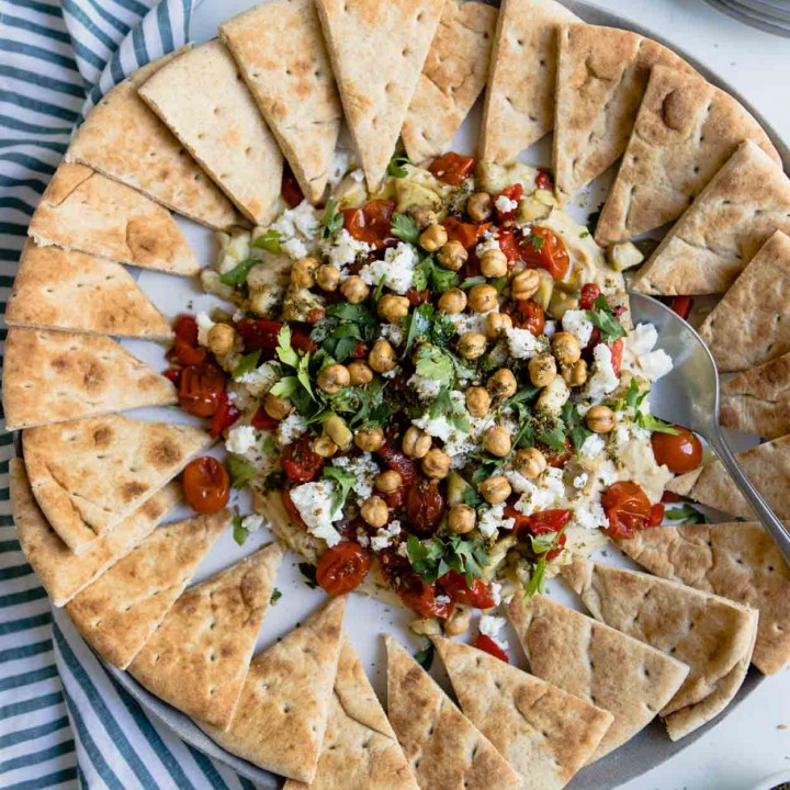 hummus with parsley, tomatoes, feta and eggplant