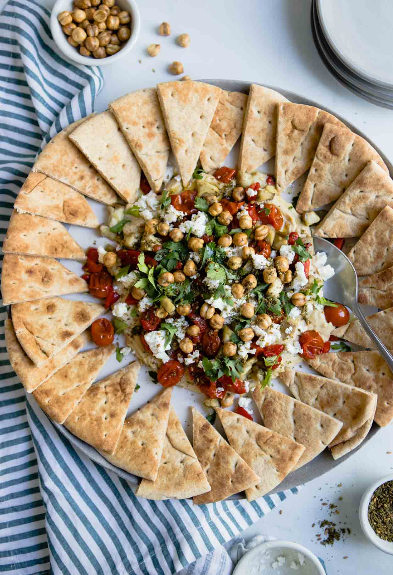 hummus with parsley, tomatoes, feta and eggplant