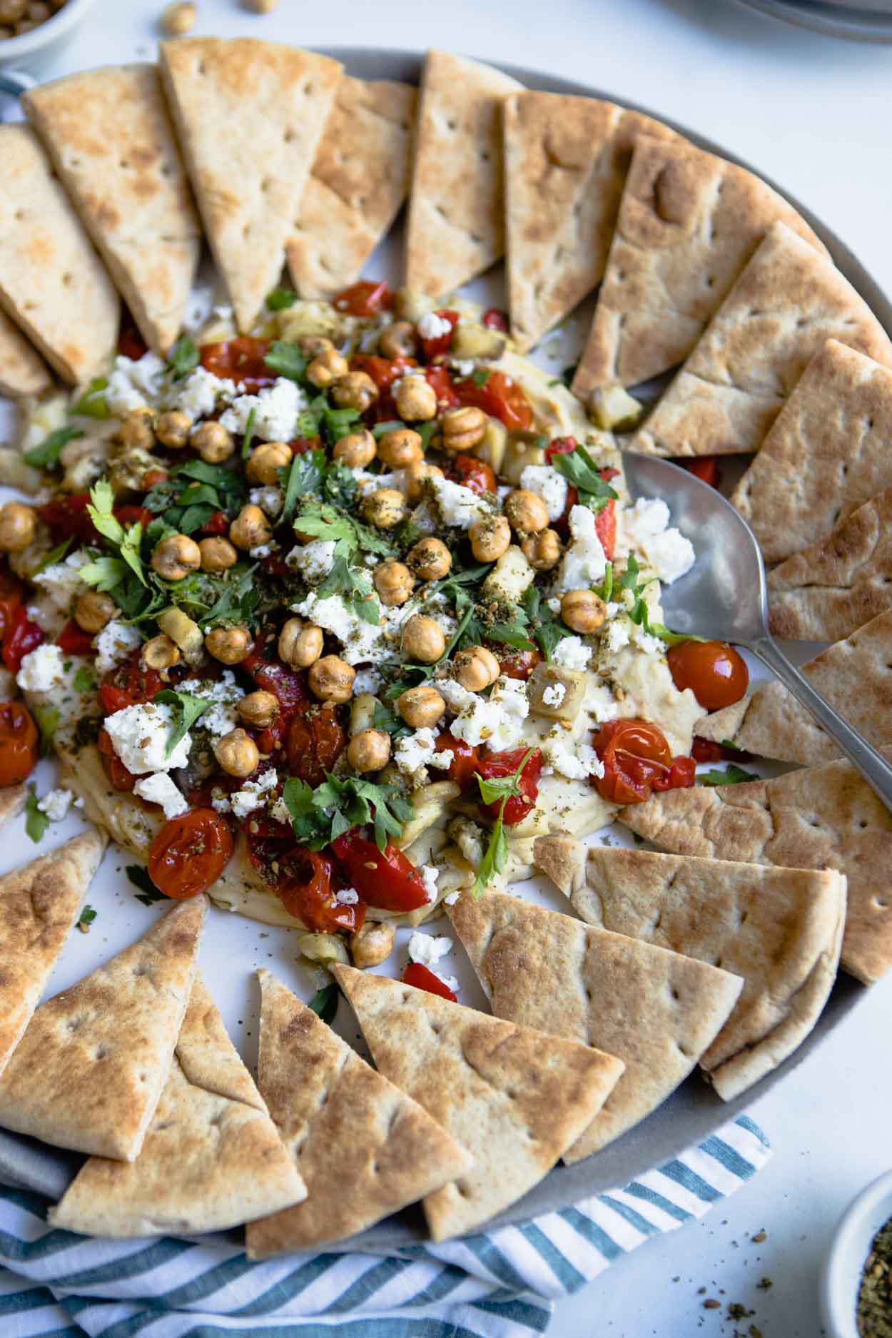 hummus with parsley, tomatoes, feta and eggplant