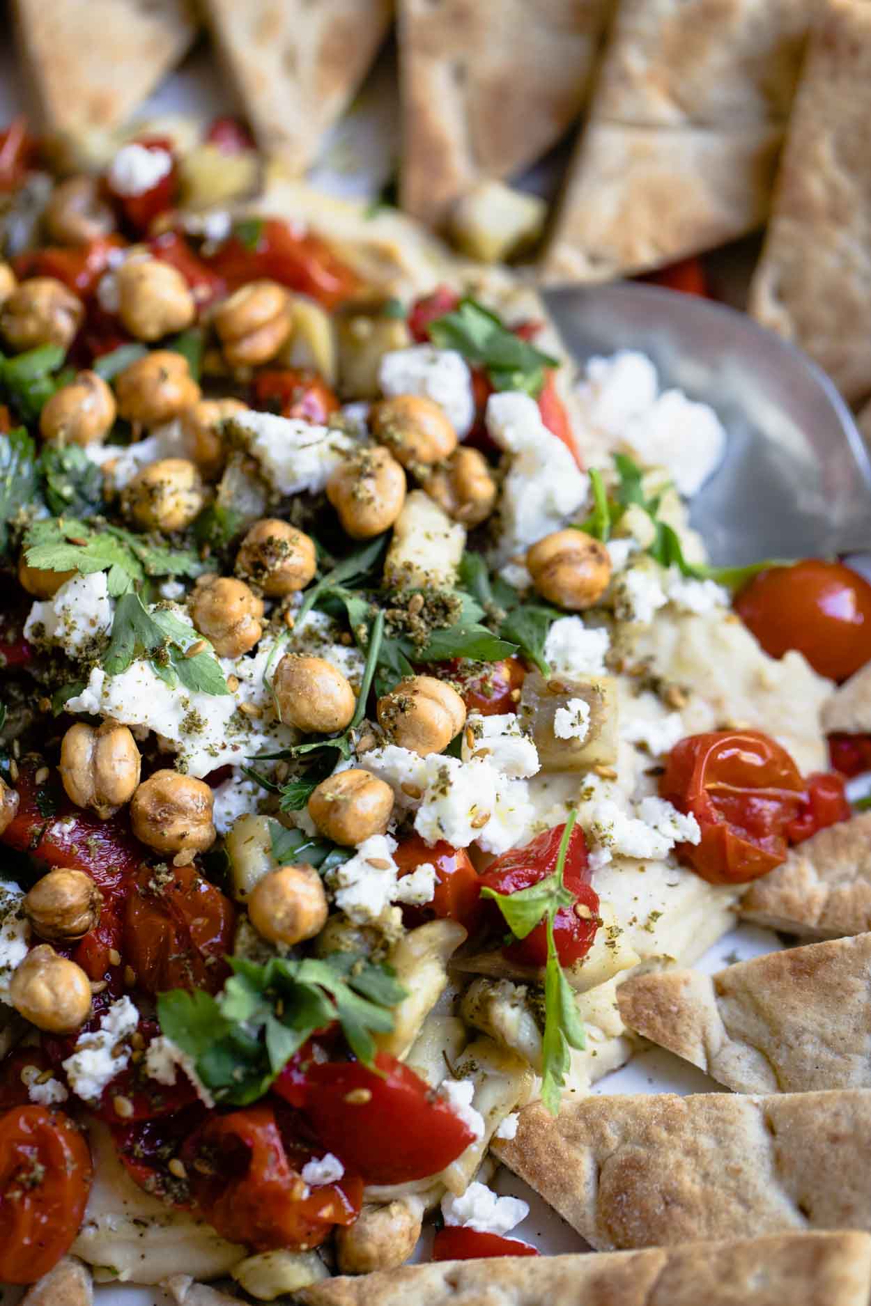 hummus with parsley, tomatoes, feta and eggplant