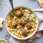 beige round bowl filled with pasta soup and meatballs