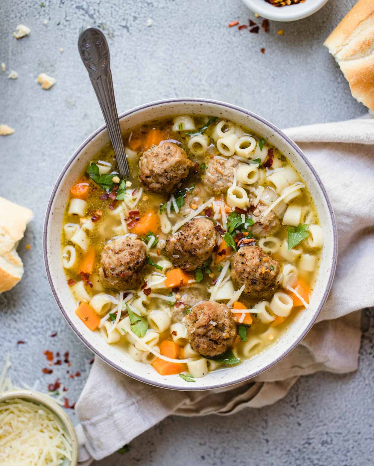 beige round bowl filled with pasta soup and meatballs