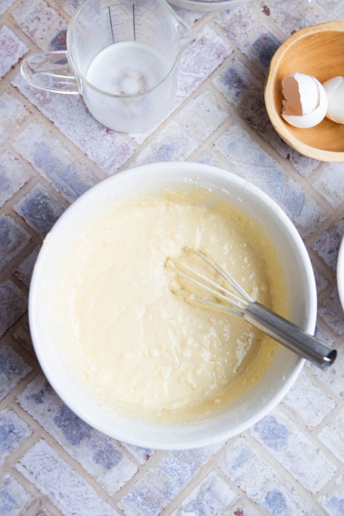 pancake batter mixed in a large ceramic bowl