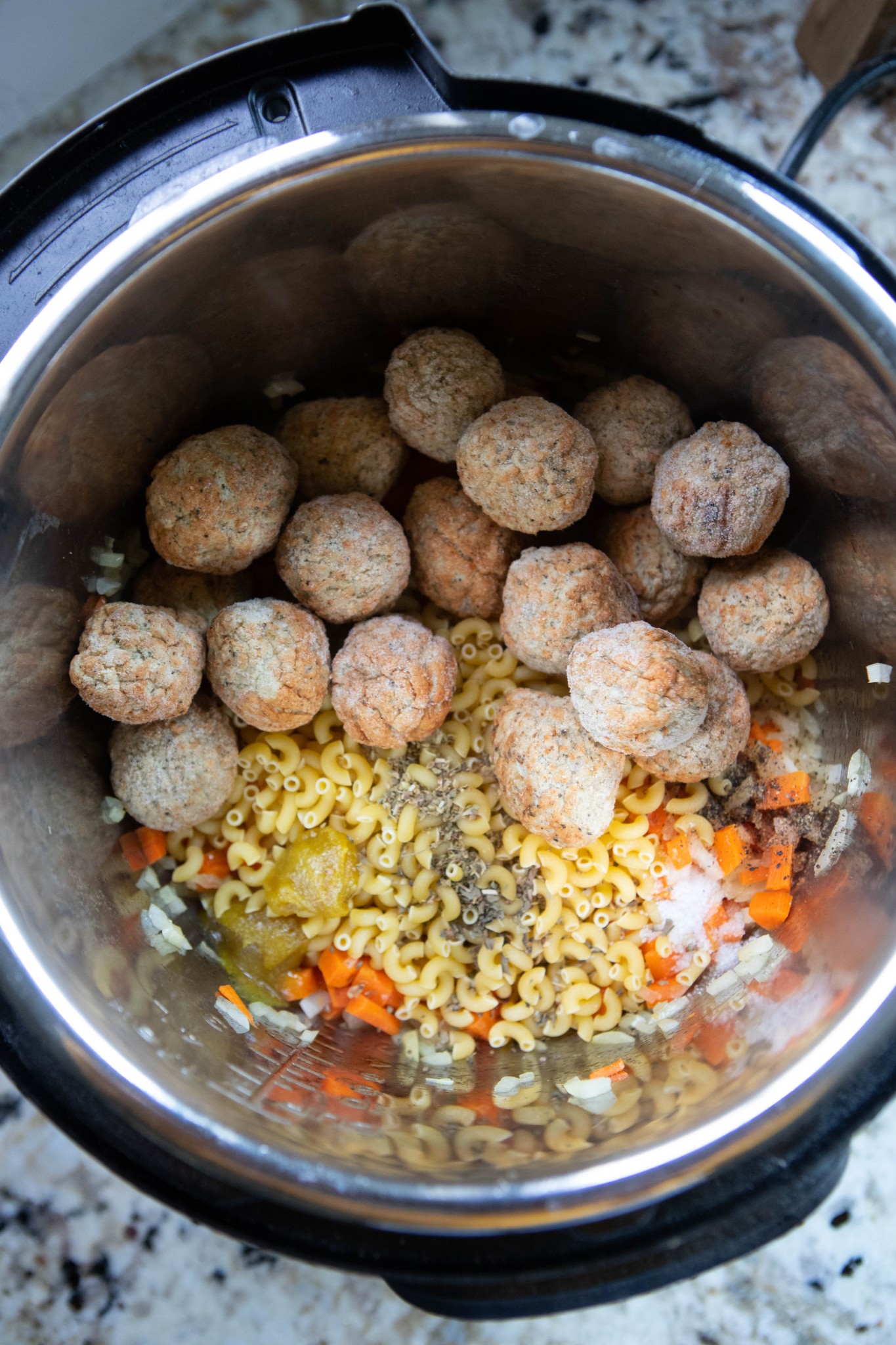 meatballs, pasta, carrots and spices in Instant Pot insert