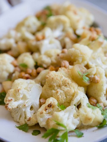 up close shot of roasted cauliflower with chickpeas and parsley