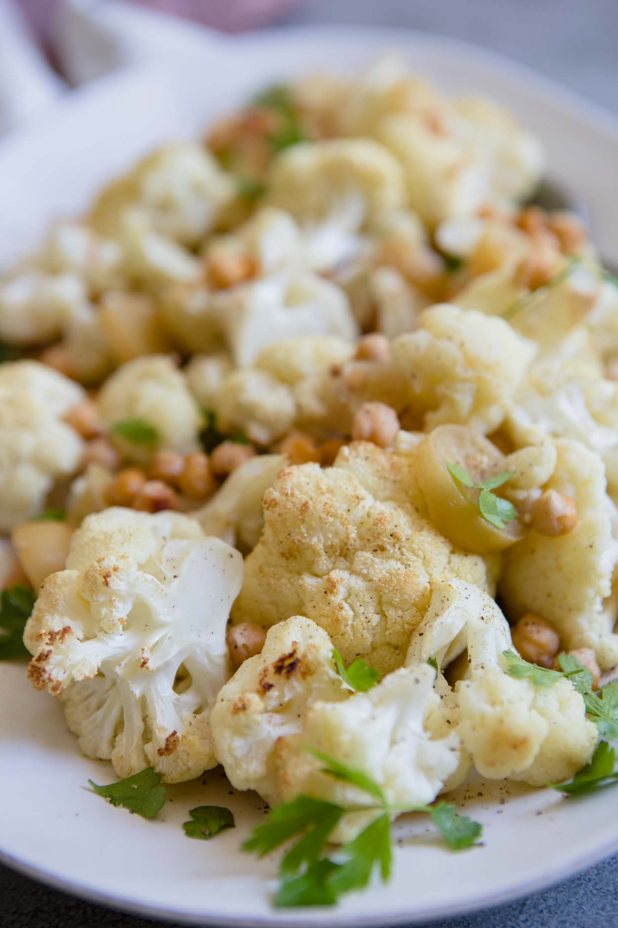 up close shot of roasted cauliflower with chickpeas and parsley