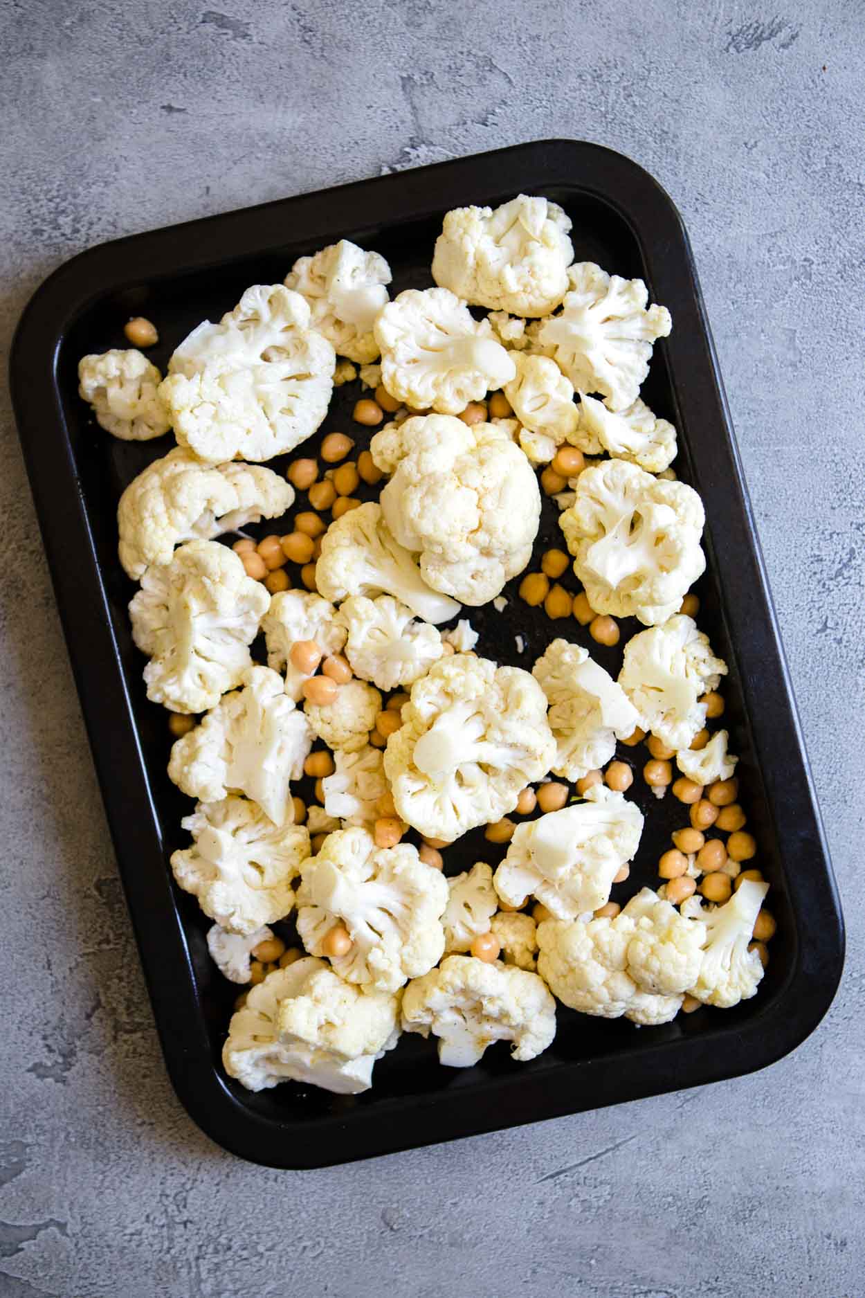 hummus and chickpeas on a baking sheet