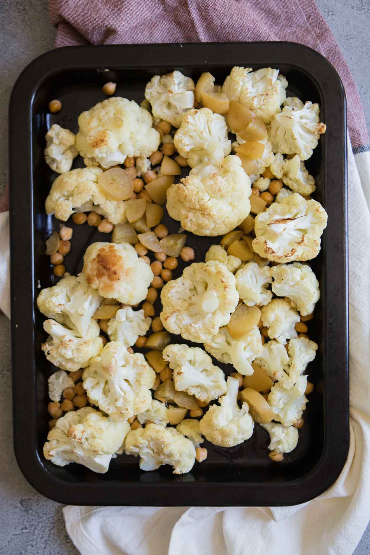 cauliflower, chickpeas, and preserved lemons on a baking sheet