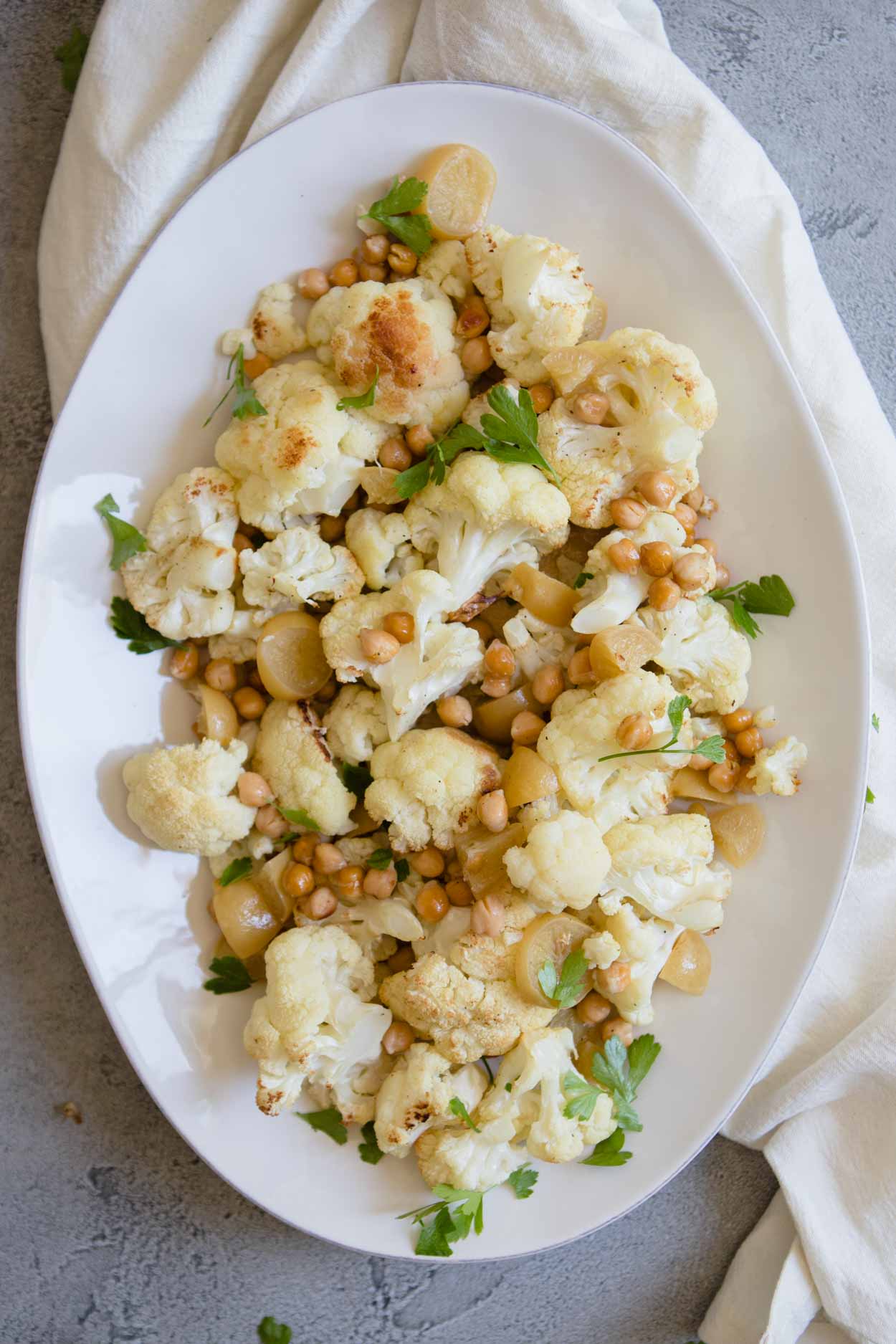 roasted cauilflower with tahini on a large white serving plate