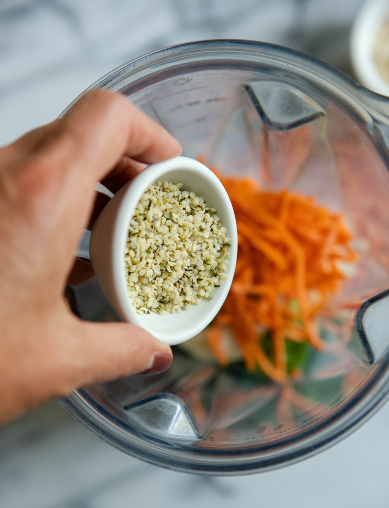 hemp seeds being poured into a blender