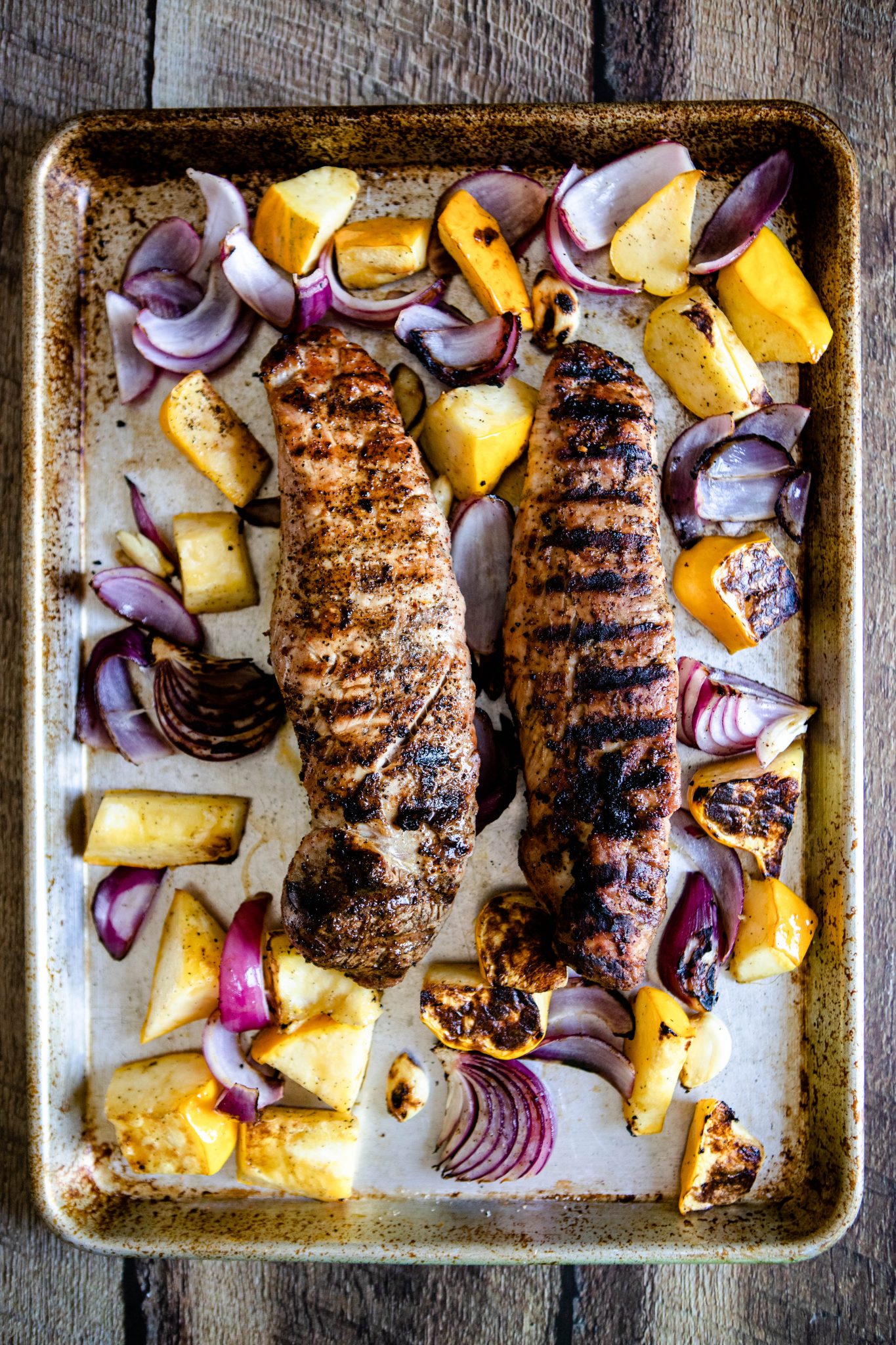 grilled bbq pork tenderloin on a sheet pan with grilled veggies 