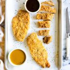 air fryer chicken cutlets on a sheet pan with 2 different types of sauces