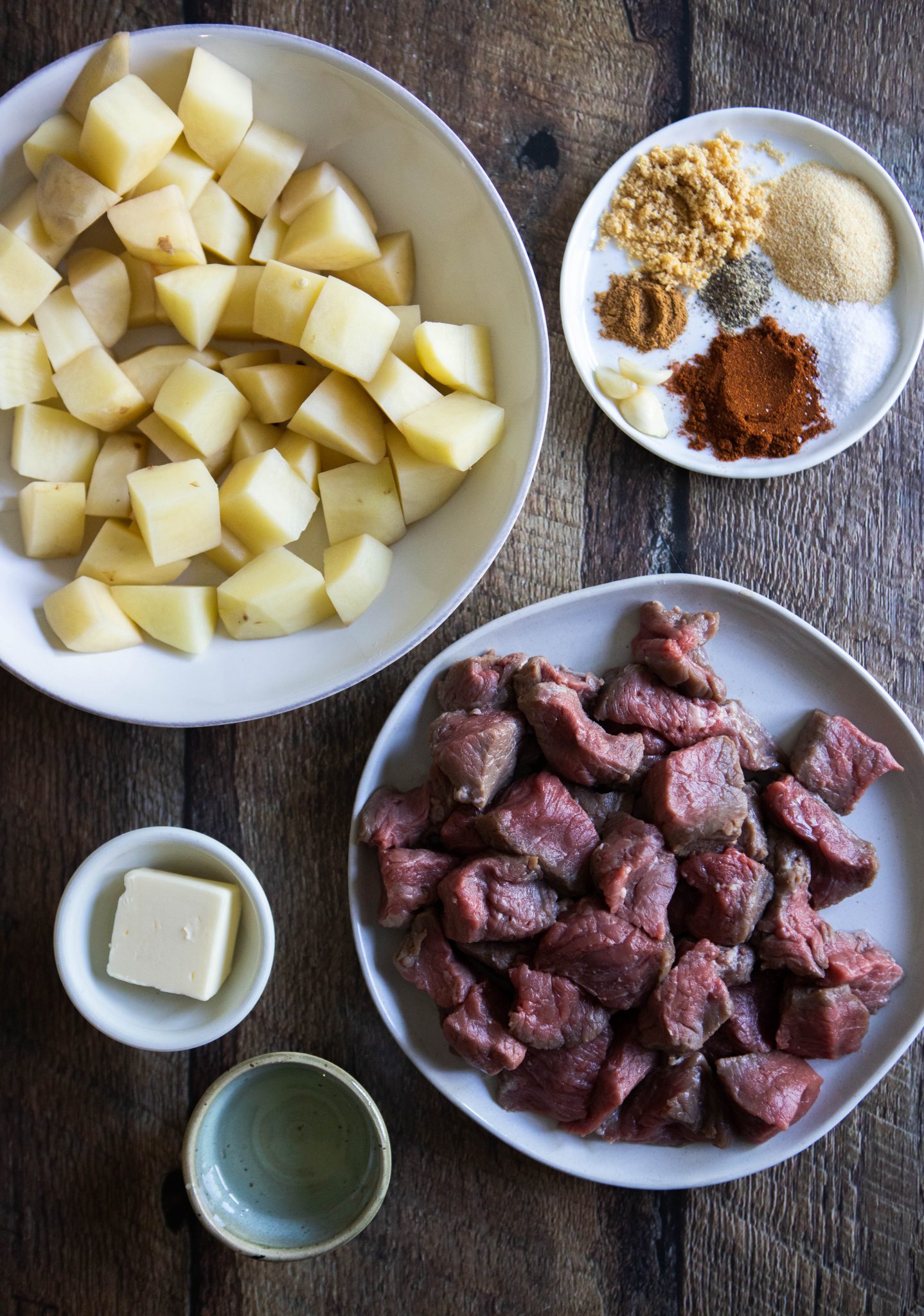 raw beef sirloin, raw potatoes, butter and herbs and spices for a top sirloin steak bites recipe