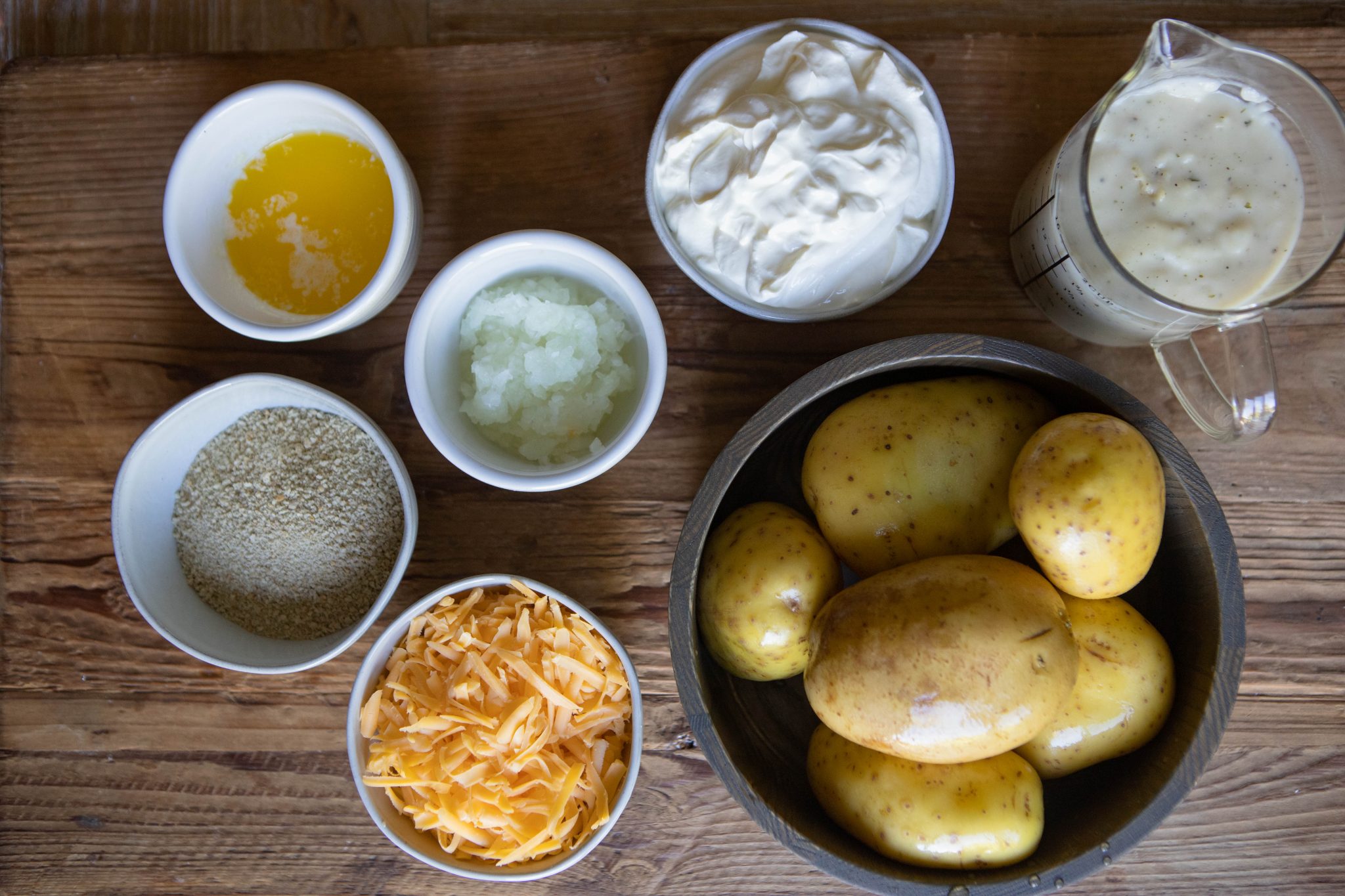 potatoes and other ingredients on a wooden board, for a casserole recipe